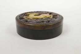 A Chinese bronze cylinder incense box with a pierced cover decorated with a gilt deer, 4½" diameter