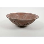 A Chinese redware bowl with reticulated lotus flower decoration to exterior and crane decoration