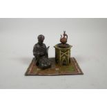 A cold painted bronze figure of a Moor on a carpet, impressed 'B' to base, 6" x 4"