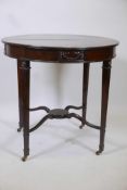 An early C20th mahogany centre table with a crossbanded top and Adam style decoration raised on