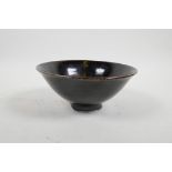 A studio pottery conical bowl with a Jian style slip glaze, 7" diameter