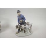 A Royal Copenhagen porcelain figurine of a boy with two calves, No 1858, 9" high, A/F