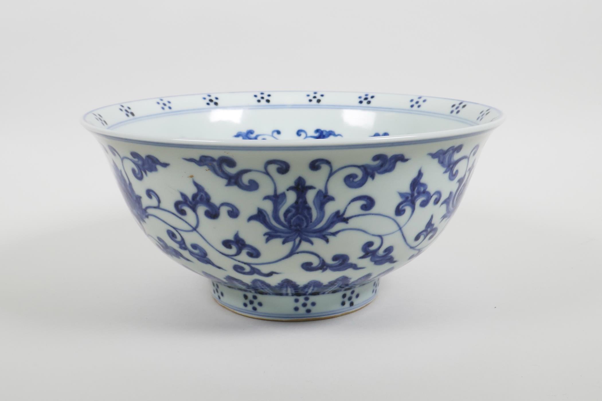 A Chinese blue and white porcelain bowl with scrolling lotus flower decoration, six character mark