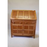 A 'Wrenman' Robert Hunter oak fall front bureau, the interior fitted with four drawers flanked by