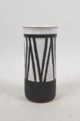 A studio pottery cylinder vase with black and white glazed decoration, 5½" high, 2½" diameter
