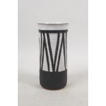 A studio pottery cylinder vase with black and white glazed decoration, 5½" high, 2½" diameter