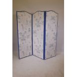 A Chinoiserie upholstered screen with four folding leaves in cream and blue fabric depicting