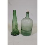 A 10¼" litre green glass bottle and another, 17½" high