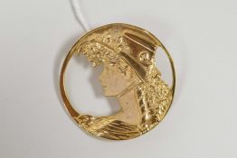 A 925 silver gilt Art Nouveau style brooch decorated with a lady in a hat, 1½" diameter
