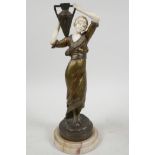 A late C19th bronze and faux ivory figure of a beautiful girl in classical Greek costume carrying