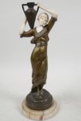 A late C19th bronze and faux ivory figure of a beautiful girl in classical Greek costume carrying