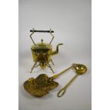 An antique brass spirit kettle with an ebony handle, together with a brass ladle and chestnut