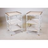 A pair of painted three tier side tables, raised on ring turned supports with brass castors and