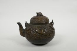A Chinese bronze teapot with raised decoration of cranes in flight, four character mark to base, 5½"