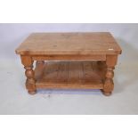 A pine two tier coffee table, raised on framed supports, 36" x 24" x 20"