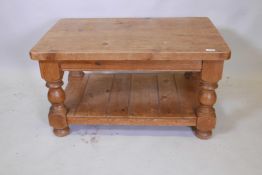 A pine two tier coffee table, raised on framed supports, 36" x 24" x 20"