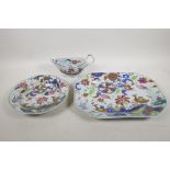 A Chinese Imari serving dish, decorated with ducks and flowers, a similar dish and sauce boat,