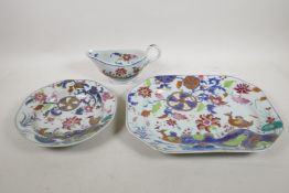A Chinese Imari serving dish, decorated with ducks and flowers, a similar dish and sauce boat,