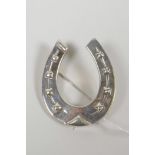 A sterling silver horseshoe brooch, 1½" x 2"