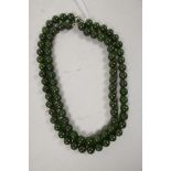 A string of vintage spinach jade beads, with silver clasp, 30" long