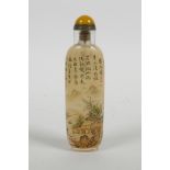 A Chinese reverse decorated snuff bottle with character inscriptions and river landscape, 4½" high