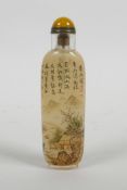 A Chinese reverse decorated snuff bottle with character inscriptions and river landscape, 4½" high