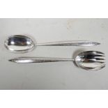 A rare pair of early C19th silver salad servers, with chased foliate decoration, by Chawner & Co (