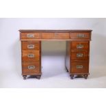 A C19th mahogany campaign pedestal desk, with long chart drawer over six drawers, fitted with