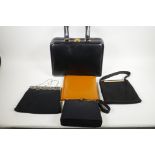 A leather vanity bag with fitted interior, 13" long, 10" high, together with three black evening