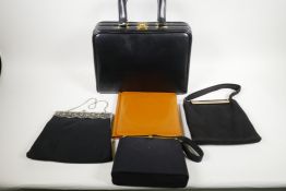 A leather vanity bag with fitted interior, 13" long, 10" high, together with three black evening