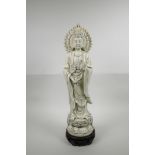 A Chinese blanc de chine Quan Yin on a lotus flower, on an associated hardwood stand, impressed seal