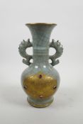 A Chinese celadon crackle glazed pottery two handled vase with applied gilt metal panels with