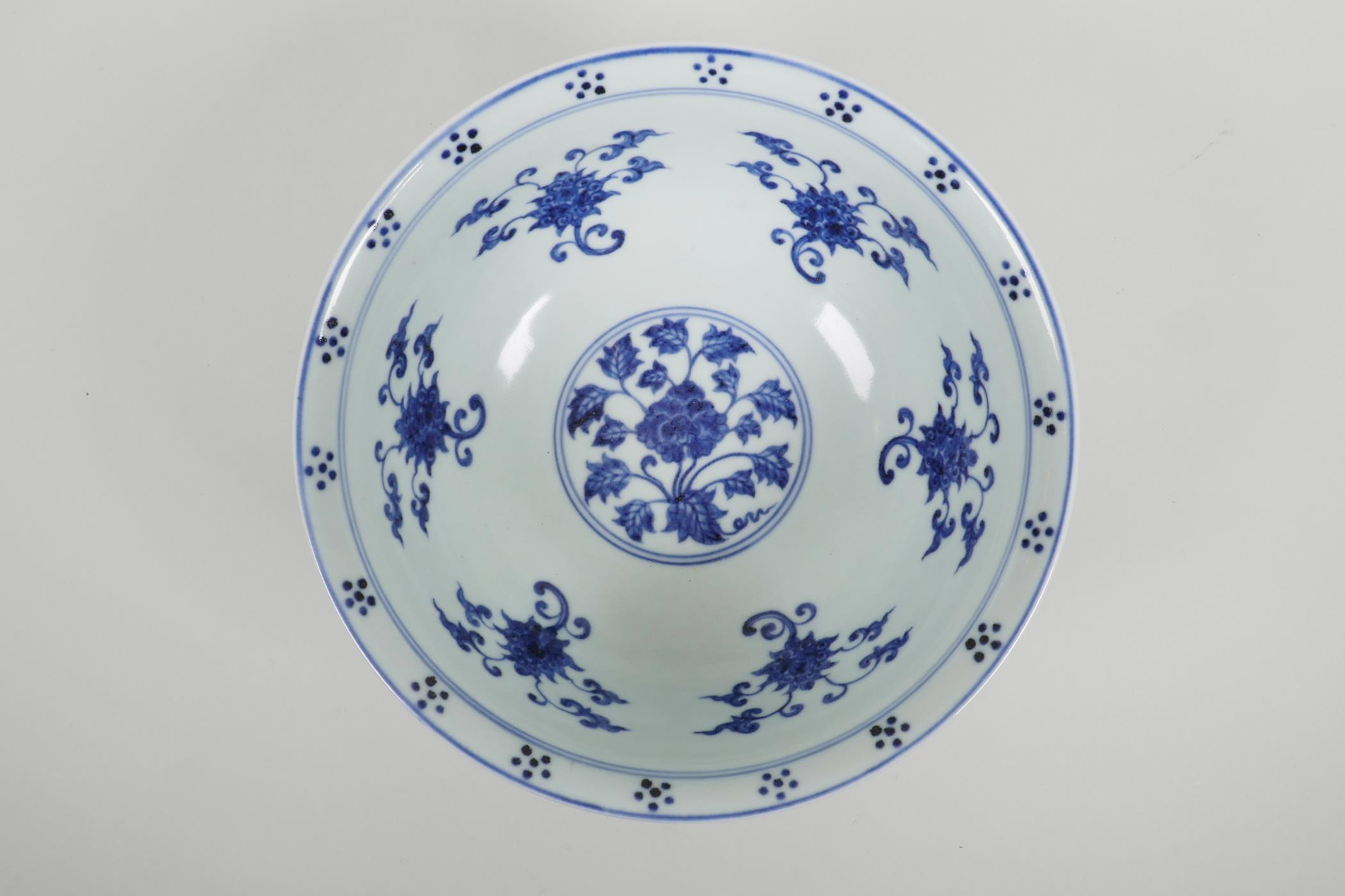 A Chinese blue and white porcelain bowl with scrolling lotus flower decoration, six character mark - Image 2 of 4
