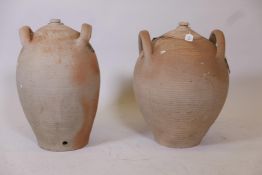 A terracotta oil jar with two handles, and another similar, largest 19½" high
