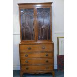 A Regency style satinwood secretaire bookcase, with astragl glazed top, base with interior fitted