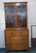 A Regency style satinwood secretaire bookcase, with astragl glazed top, base with interior fitted