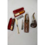 A collection of smoking related items including two cigarette holders, one with silver ferule, a
