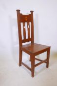 An Arts & Crafts oak hall chair, 41" high