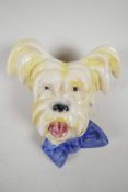 An Art Deco terrier head ceramic wall plaque with blue bow tie, hook verso, 8" high x 6½? wide