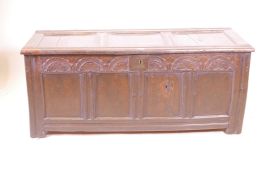 A late C17th/early C18th four panel oak coffer with carved frieze decoration, with later repairs,