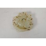 A Chinese white jade pendant carved in the form of a monkey riding a horse, 2" diameter