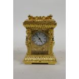 An ornate gilt brass miniature carriage clock with classical decoration, 3½" high