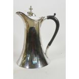 An Arts and Crafts design silver plated hot water jug with ebony handle made, by James Deakin &