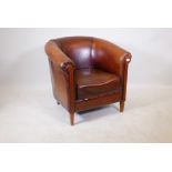 A brown leather club chair, 31" high