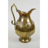 A heavy oriental bronze ewer set with applied cabochon gemstones and plaques of exotic animals and a