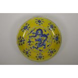 A Chinese Ming style yellow ground porcelain dish with blue and white dragon decoration, seal mark