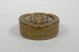 A gilt metal cylinder patch box with heraldic eagle decoration to cover, 2½" diameter