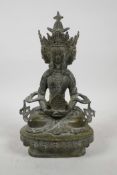 A Sino-Tibetan bronze four-faced deity with verdigris patina, 8½" high