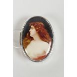A sterling silver pill box with a cold enamel plaque depicting a semi-clad woman, 1" x 1½"