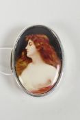 A sterling silver pill box with a cold enamel plaque depicting a semi-clad woman, 1" x 1½"